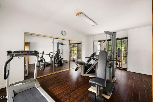 workout room with wood finished floors and baseboards