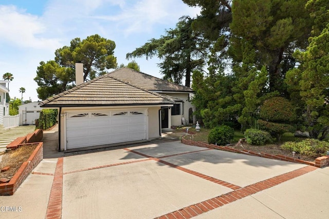 single story home with a tiled roof and fence