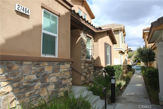 27464 Honeydew Ct, Saugus, CA 91350 - view of side of home featuring stone siding and stucco siding