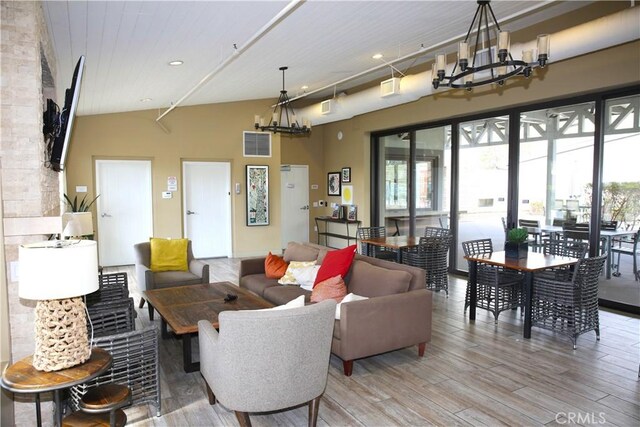 27464 Honeydew Ct, Saugus, CA 91350 - living area featuring light wood-type flooring, a chandelier, vaulted ceiling, and recessed lighting