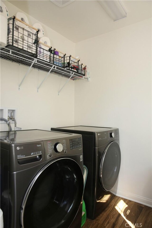 27464 Honeydew Ct, Saugus, CA 91350 - laundry room featuring independent washer and dryer, dark wood-type flooring, and baseboards