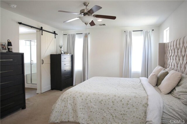27464 Honeydew Ct, Saugus, CA 91350 - bedroom featuring a barn door, multiple windows, light colored carpet, and ceiling fan