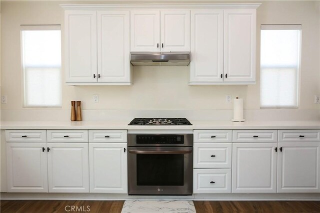 27464 Honeydew Ct, Saugus, CA 91350 - kitchen with oven, under cabinet range hood, black gas cooktop, white cabinets, and light countertops