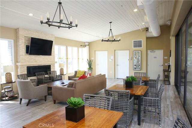 27464 Honeydew Ct, Saugus, CA 91350 - living area with a chandelier, wood-type flooring, a large fireplace, wood ceiling, and lofted ceiling