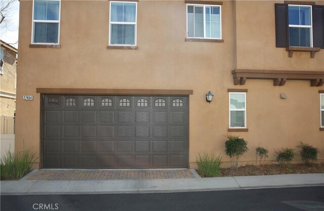 27464 Honeydew Ct, Saugus, CA 91350 - view of front of property featuring stucco siding, a garage, and driveway