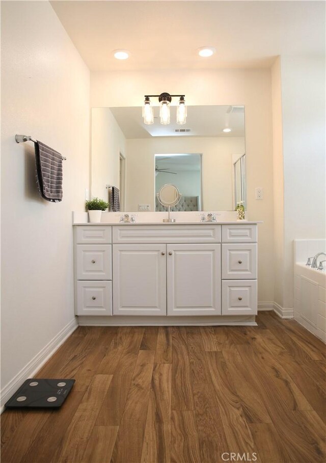 27464 Honeydew Ct, Saugus, CA 91350 - full bath featuring vanity, wood finished floors, a garden tub, and baseboards