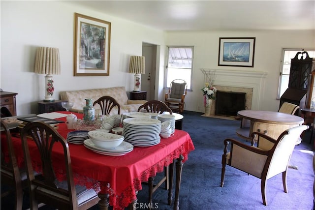 carpeted dining space featuring a high end fireplace