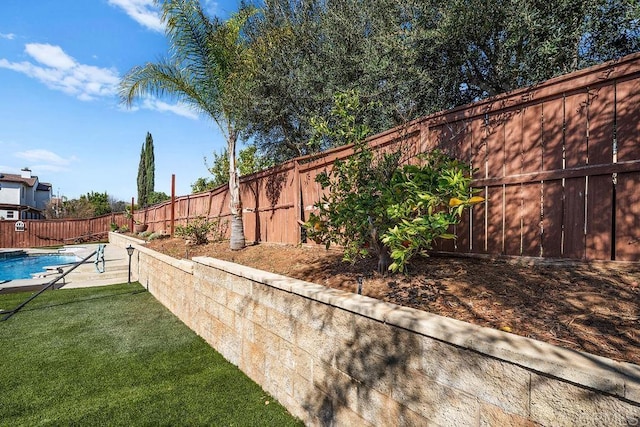 view of yard with a fenced backyard and a fenced in pool