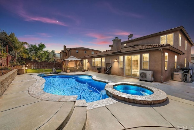 view of swimming pool with a patio, fence, a gazebo, ac unit, and a pool with connected hot tub