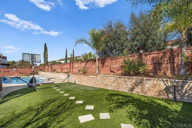 view of yard featuring a fenced in pool and a fenced backyard