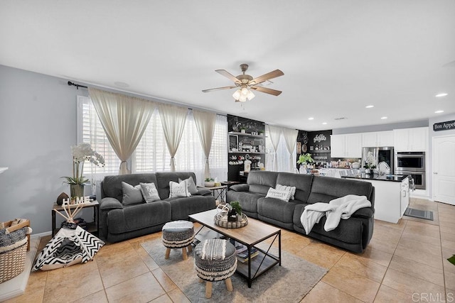 living area with ceiling fan, light tile patterned flooring, and recessed lighting