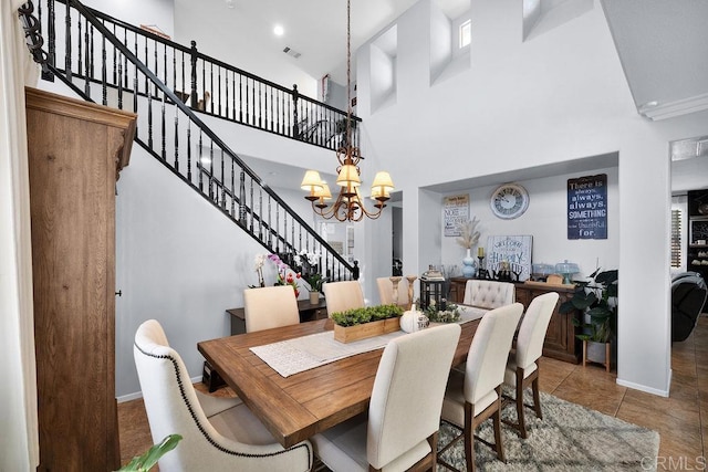 tiled dining space with stairs, baseboards, visible vents, and an inviting chandelier