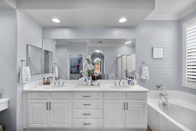 full bath with a sink, a shower stall, and double vanity