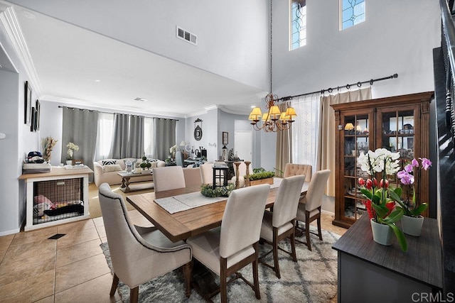 dining room featuring light tile patterned floors, ornamental molding, a chandelier, and visible vents