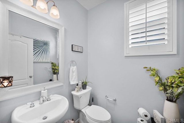 half bathroom with a sink and toilet