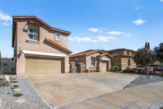 mediterranean / spanish-style house featuring a garage, a tiled roof, concrete driveway, and stucco siding