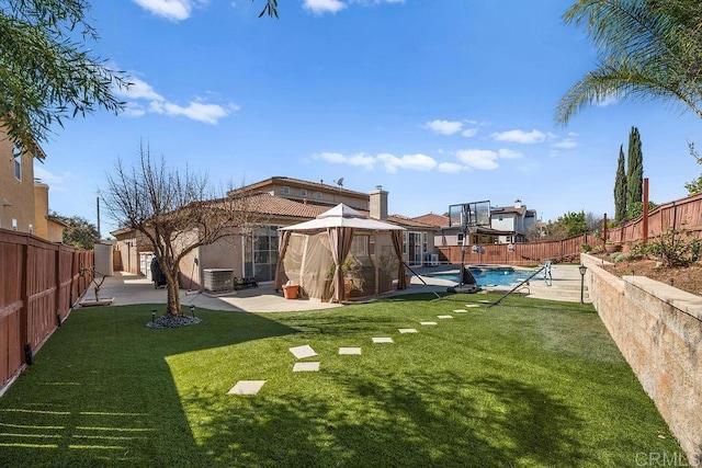 view of yard with a fenced in pool, a patio, a gazebo, central AC unit, and a fenced backyard