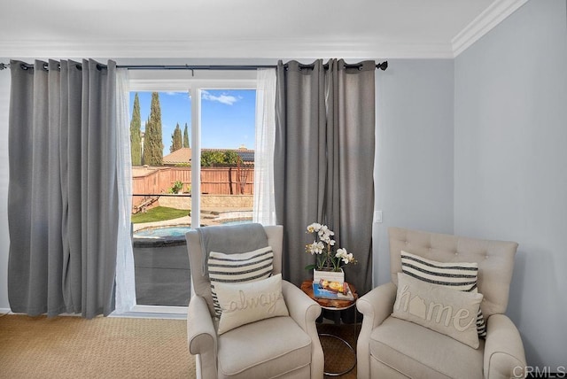 sitting room with carpet floors and ornamental molding