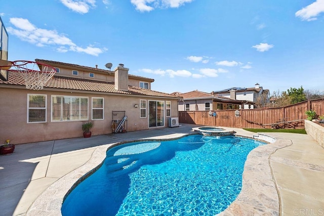 view of pool featuring ac unit, a patio area, a fenced backyard, and a pool with connected hot tub