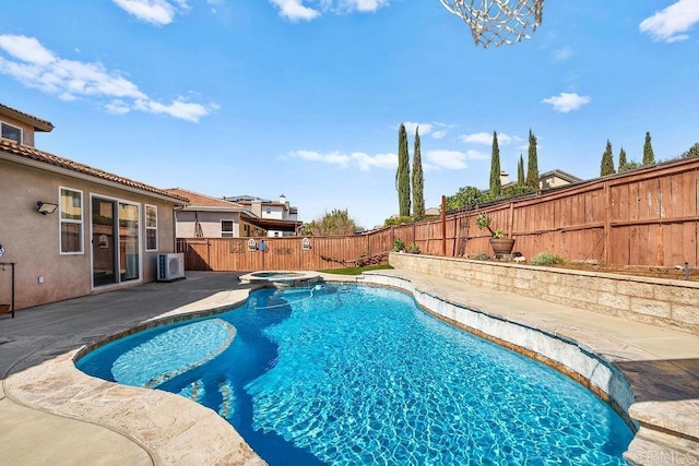 view of pool with a patio, central AC, a fenced backyard, and a pool with connected hot tub