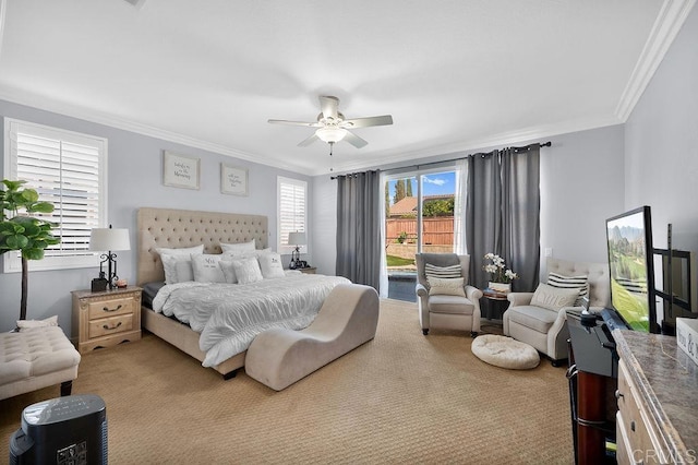 carpeted bedroom featuring ornamental molding and a ceiling fan