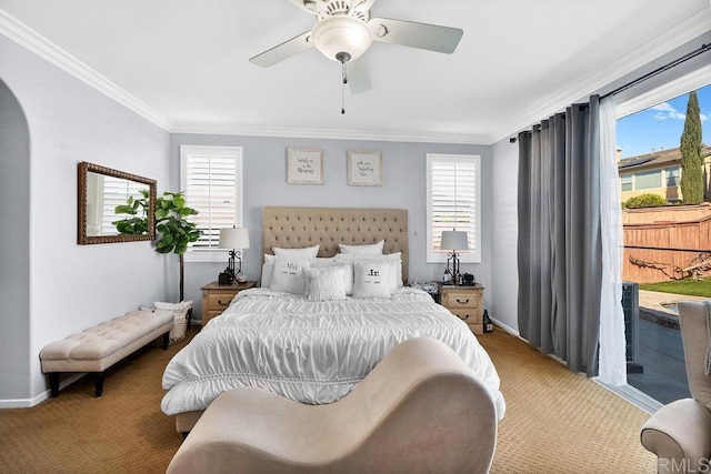 bedroom featuring arched walkways, carpet floors, baseboards, access to outside, and ornamental molding