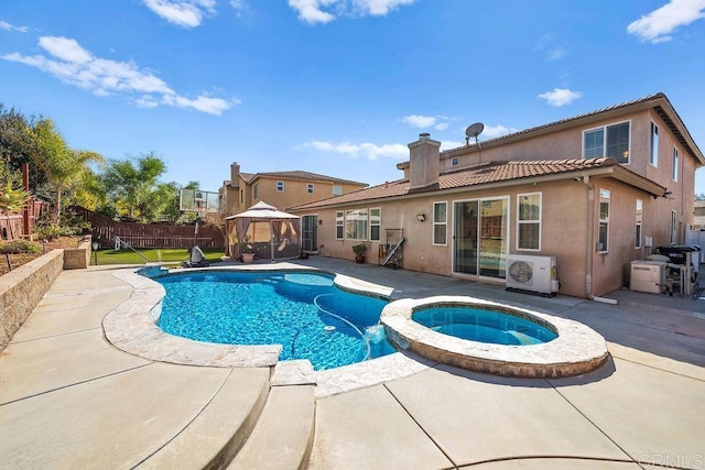 view of pool featuring a patio, fence, a gazebo, ac unit, and a pool with connected hot tub