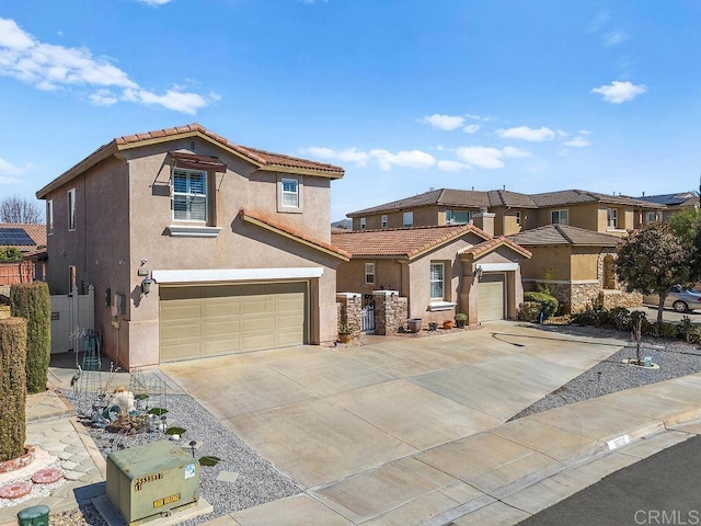 view of front of home featuring concrete driveway, an attached garage, a tiled roof, and stucco siding