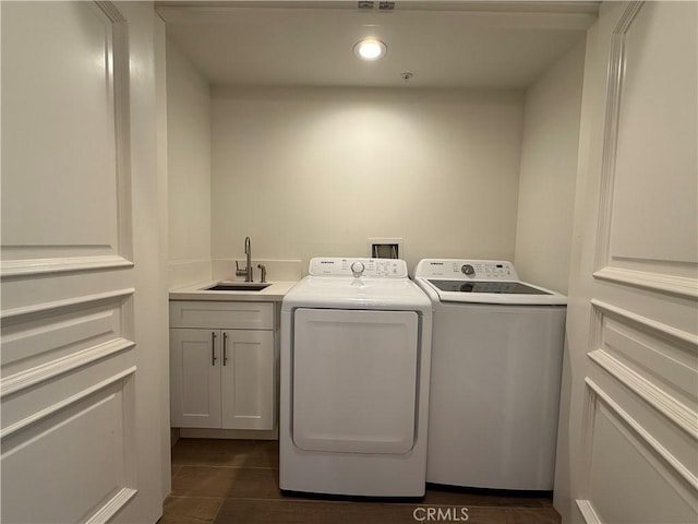 washroom with cabinet space, separate washer and dryer, a sink, and recessed lighting