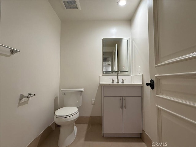 bathroom with toilet, baseboards, visible vents, and vanity