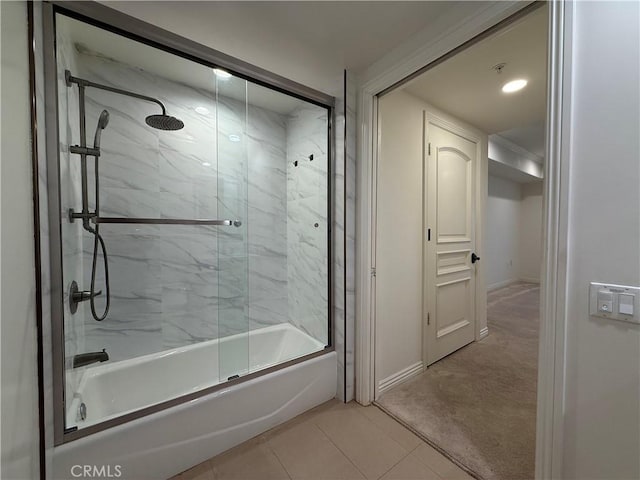 full bath featuring shower / bath combination with glass door, baseboards, and tile patterned floors