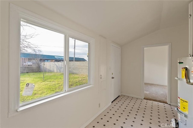 812 Toomes Ave, Corning, CA 96021 - doorway to outside with lofted ceiling, light floors, baseboards, and secured water heater