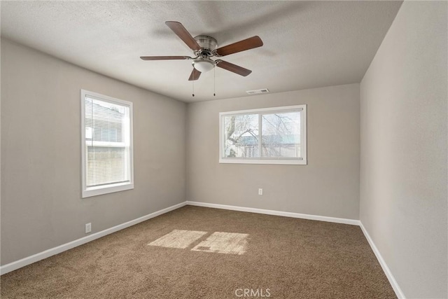 812 Toomes Ave, Corning, CA 96021 - carpeted spare room featuring baseboards, visible vents, and plenty of natural light