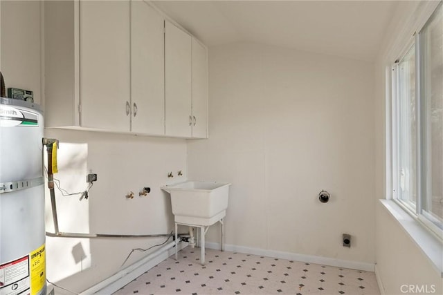 812 Toomes Ave, Corning, CA 96021 - laundry area featuring cabinet space, hookup for an electric dryer, water heater, light floors, and baseboards