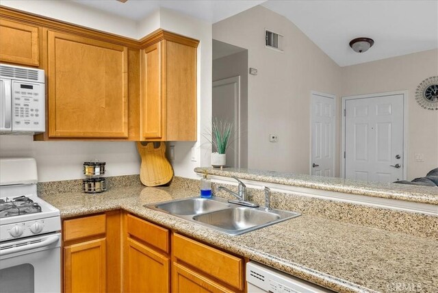 kitchen featuring light countertops, white appliances, visible vents, and a sink