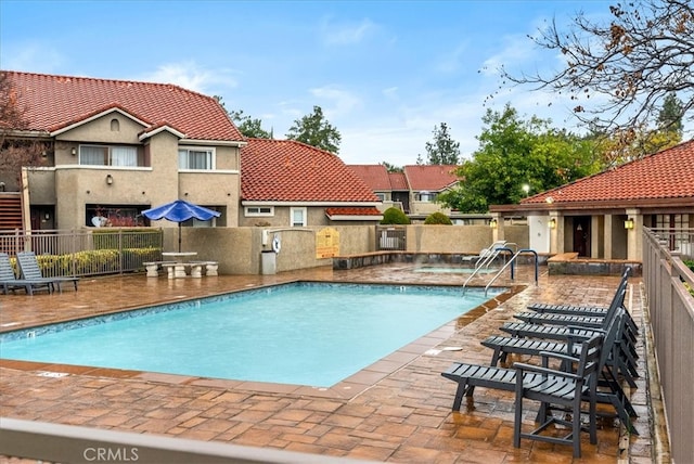 pool featuring a patio area and fence