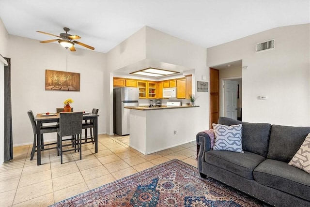 living room featuring light tile patterned floors, baseboards, visible vents, and a ceiling fan