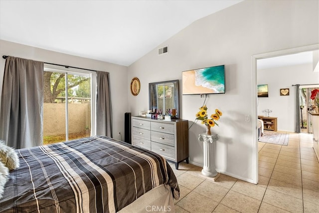 bedroom with lofted ceiling, light tile patterned floors, visible vents, and baseboards