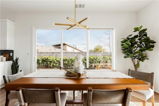 dining area featuring wood finished floors and visible vents