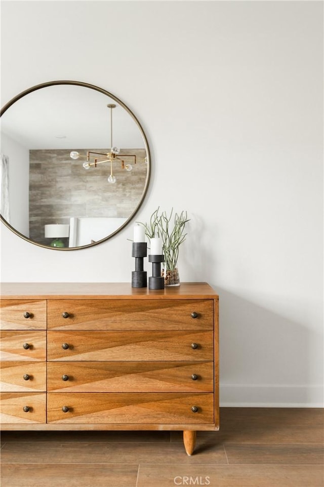 interior space featuring baseboards and wood finished floors