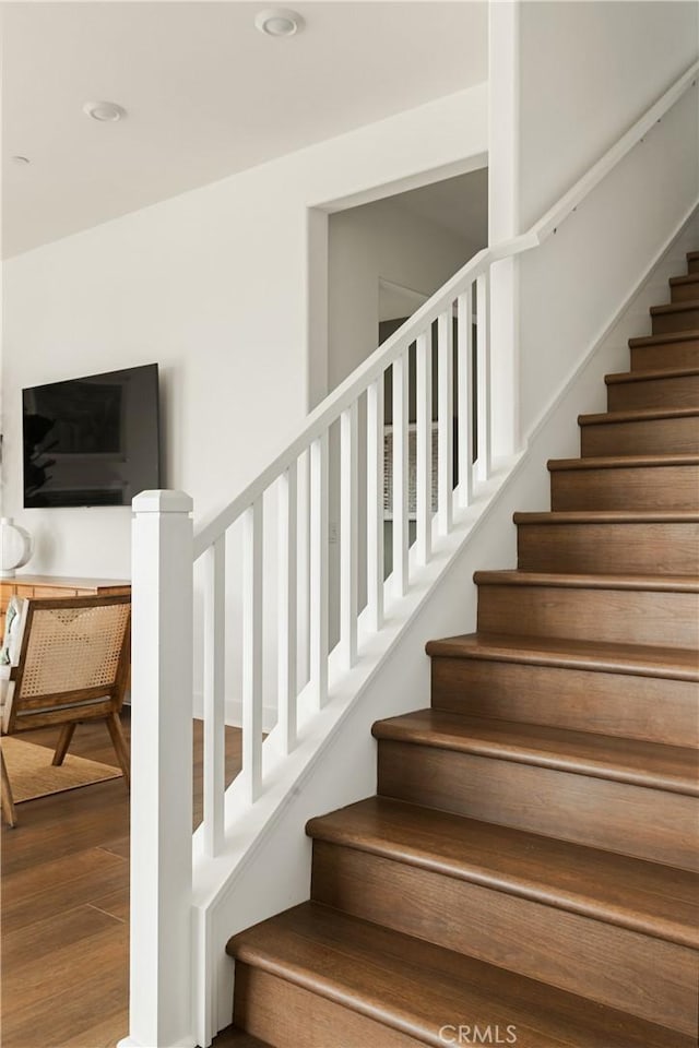 staircase with wood finished floors