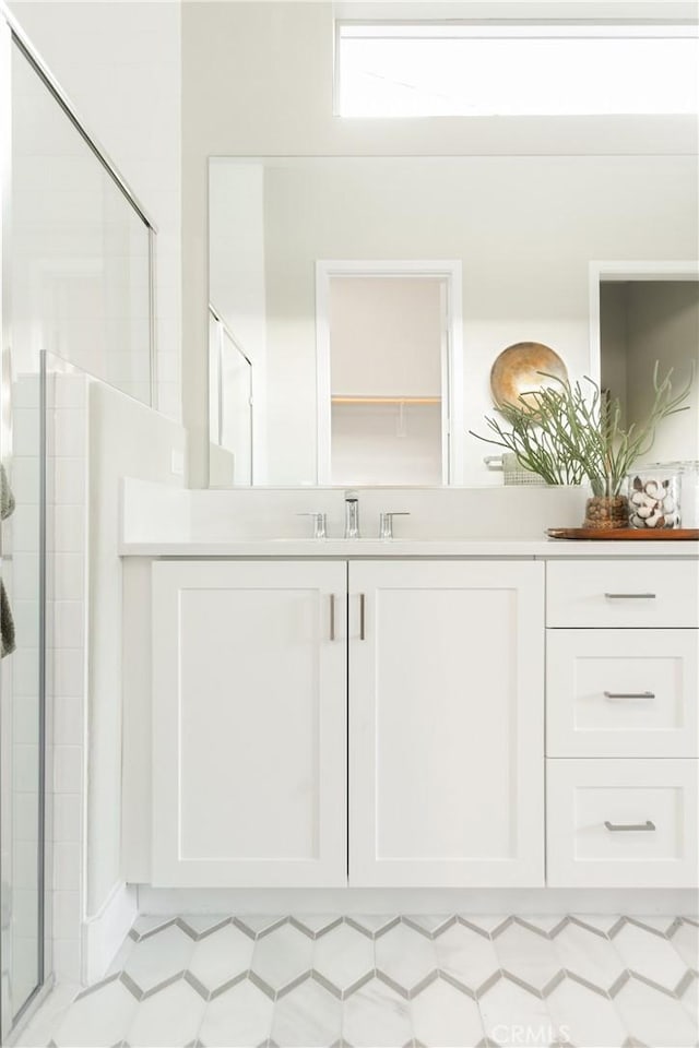 full bathroom with a stall shower and vanity