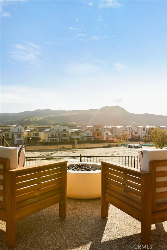 exterior space featuring a balcony, a mountain view, and a residential view