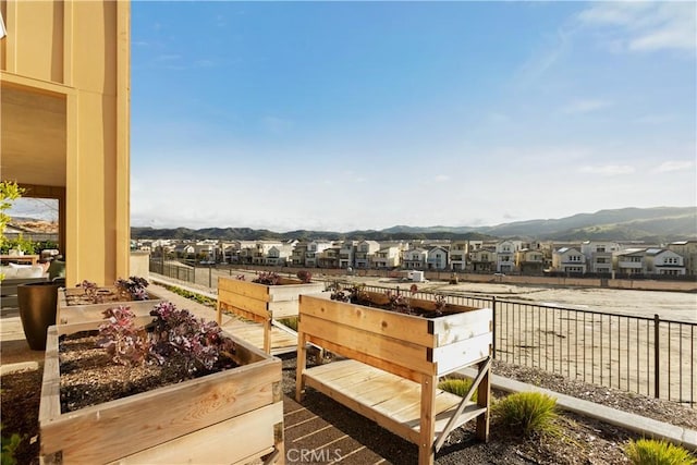 view of yard featuring a residential view, fence, and a garden