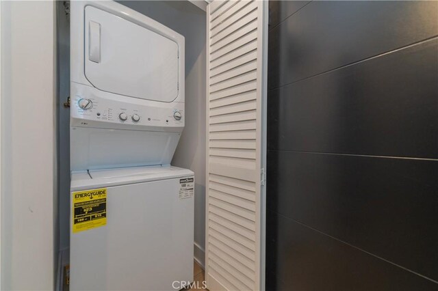 washroom featuring laundry area and stacked washer / dryer