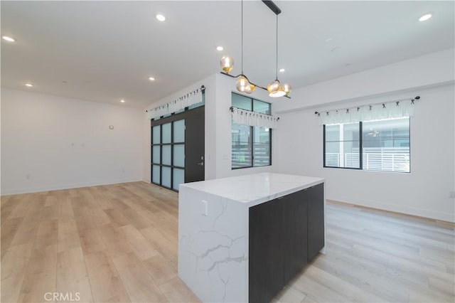 kitchen featuring light wood-style floors, recessed lighting, open floor plan, and a barn door