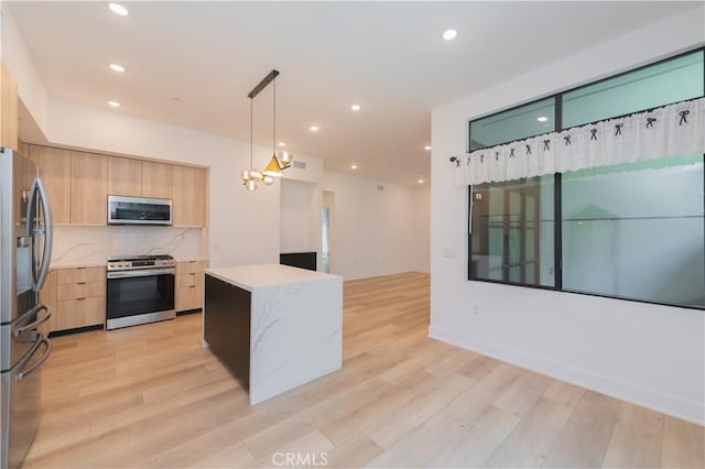 kitchen with stainless steel appliances, light brown cabinetry, modern cabinets, and decorative backsplash