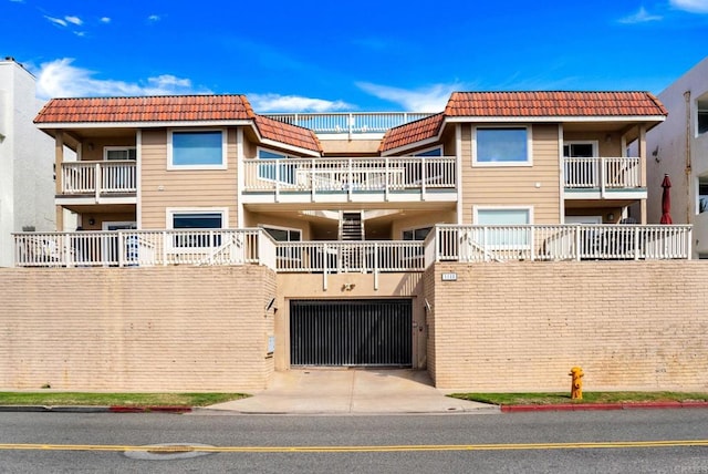 view of building exterior with concrete driveway and an attached garage