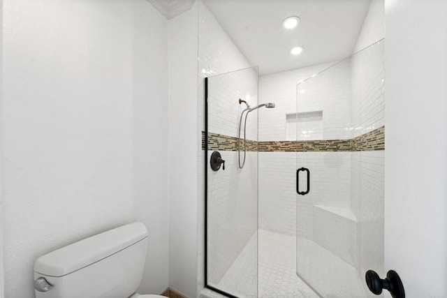 bathroom featuring a stall shower, toilet, and recessed lighting