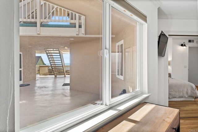 interior space with wood finished floors and crown molding